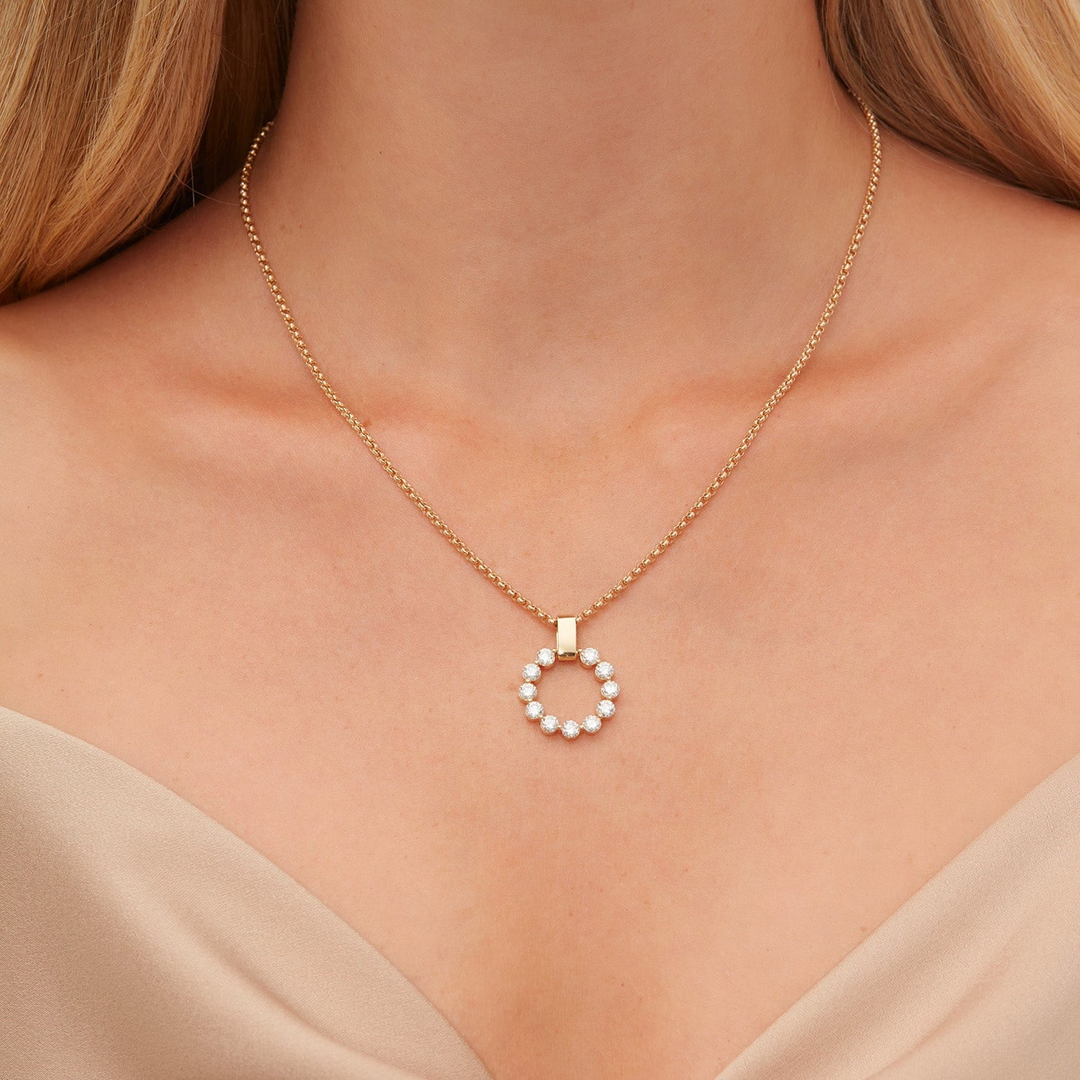 Model wearing the MICHAEL M Large Cloud diamond circle pendant on a gold chain with a beige top