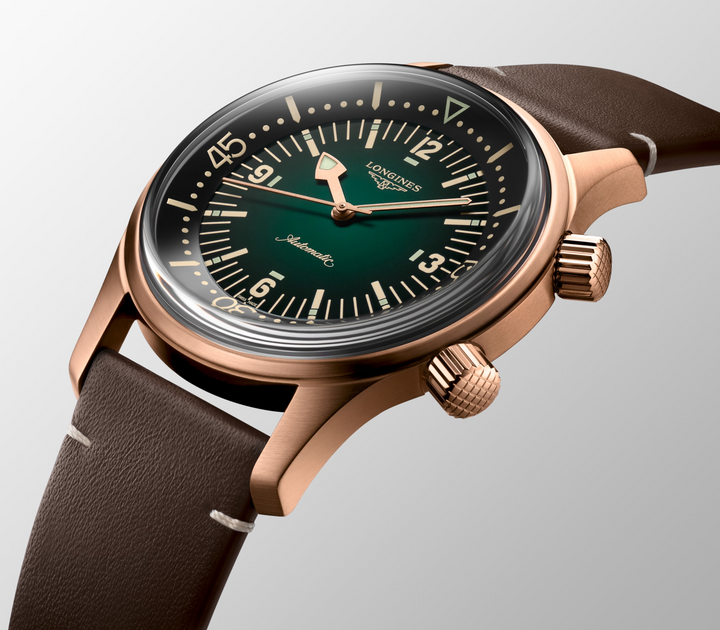 Close up front view of a LONGINES Legend Diver Bronze watch with a dark green dial and a brown leather strap.