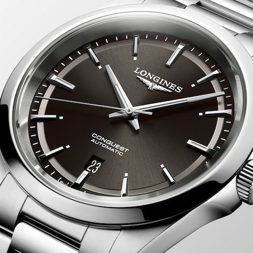 Close-up of the LONGINES Conquest dark dial with applied hour markers, silver-tone hands and a date window.