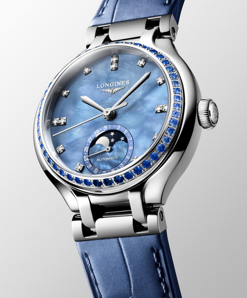 side view of womens longines watch with blue pearl dial blue leather strap and stainless steel case