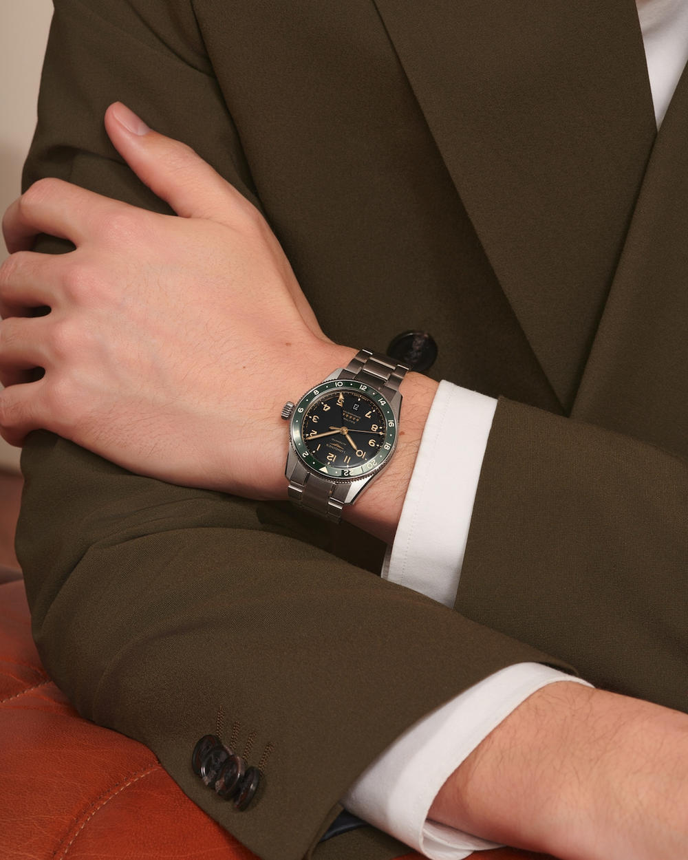 LONGINES Spirit Zulu Time L3.802.4.63.6 Stainless Steel Watch Worn on Wrist With Orange Jacket