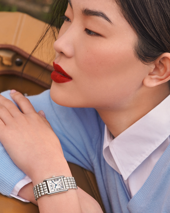 Female in a blue shirt wearing a LONGINES Mini DolceVita with stainless-steel bracelet. 29mm case. 