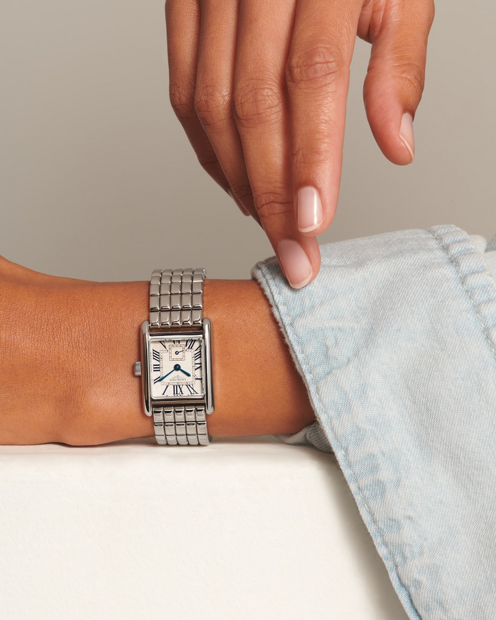 Close up of a woman's arm wearing a LONGINES Mini DolceVita with stainless-steel bracelet. 29mm case. 
