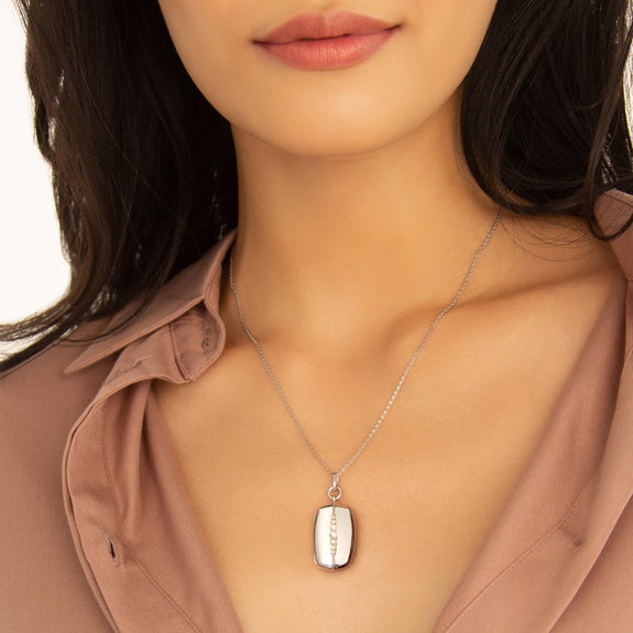 Model wearing the Monica Rich Kosann Kate rectangular sterling silver locket necklace with white sapphire accents.