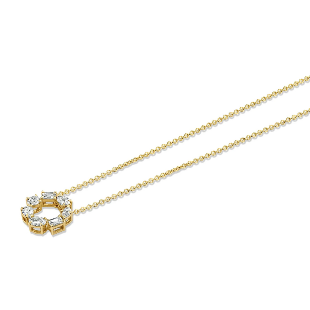 An angled view of a yellow gold pendant necklace laid out against a white background. The ring features two pear-cut diamonds, two emerald-cut diamonds, one marquise-cut diamond, one round-cut diamond, and one oval-cut diamond custer design pendant.
