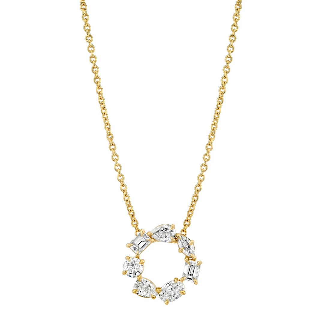 A front view of a yellow gold pendant necklace against a white background. The ring features two pear-cut diamonds, two emerald-cut diamonds, one marquise-cut diamond, one round-cut diamond, and one oval-cut diamond custer design pendant.