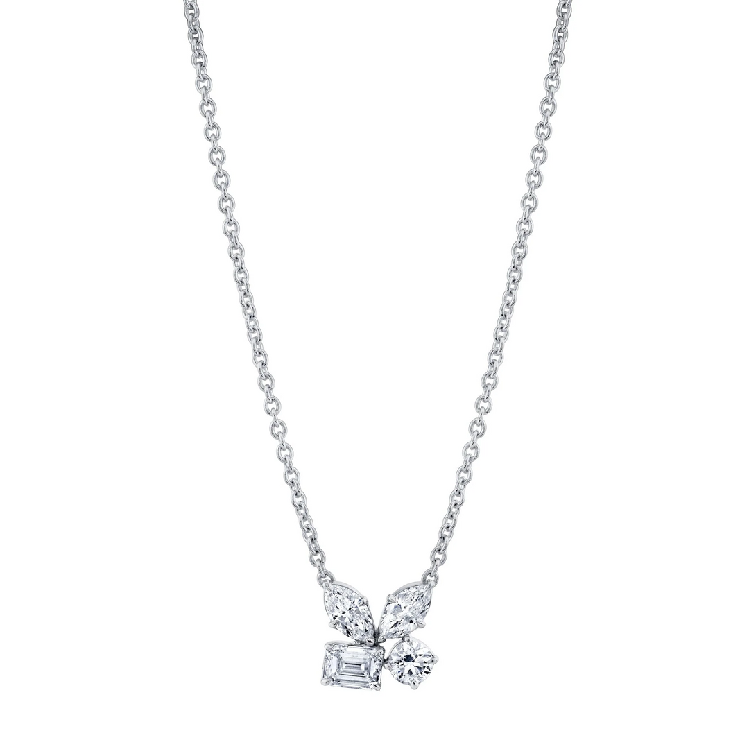 A front view of a white gold necklace against a white background. The necklace features two marquise, one emerald, and one round-cut diamond cluster design center piece on the necklace.
