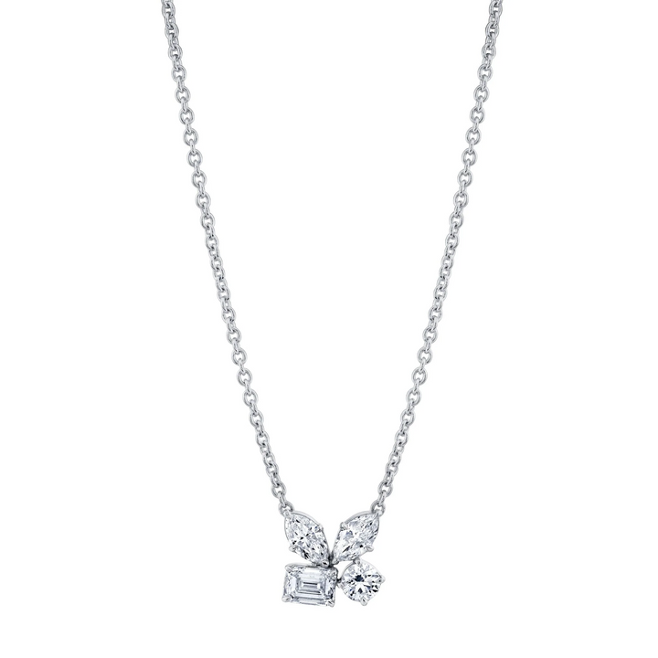 A front view of a white gold necklace against a white background. The necklace features two marquise, one emerald, and one round-cut diamond cluster design center piece on the necklace.
