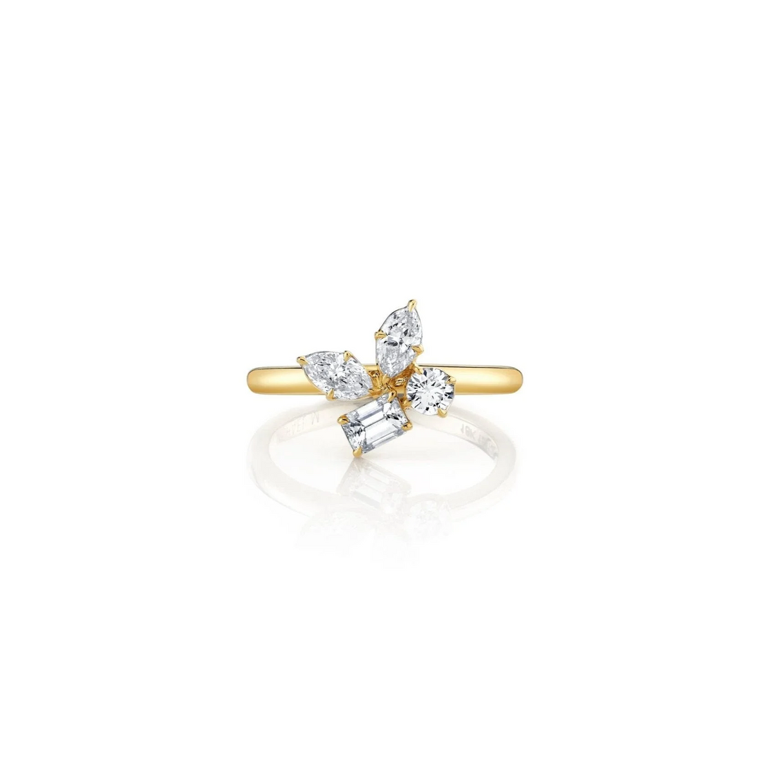 A front view of a yellow gold ring against a white background. The ring features marquise, pear, and emerald cut stones in a cluster design center piece on a yellow gold band.
