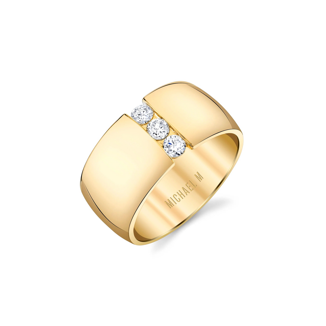 An angled view of a yellow gold diamond ring against a white background. The ring features the timeless ring shape split down the middle with a perfect line of floating diamonds.