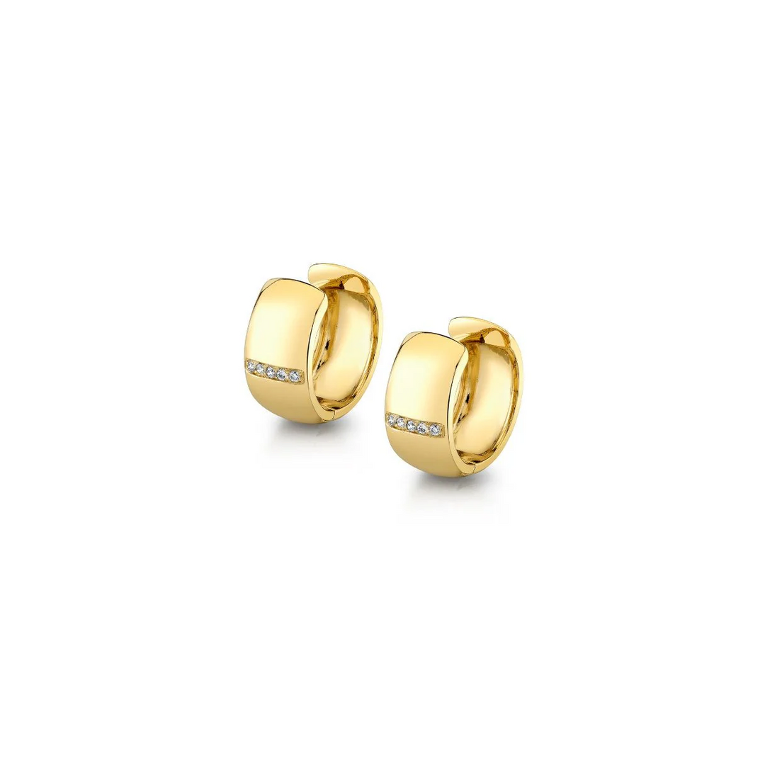 An angled view of yellow gold earrings against a white background. The earrings feature a wide huggie design with a single row of diamonds in the middle in the front.