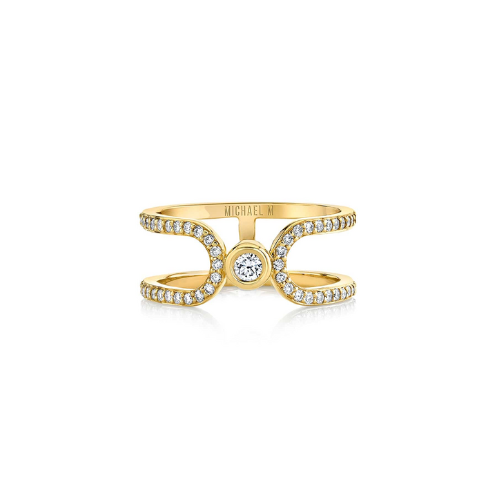 A front view of a yellow gold wedding band against a white background. The ring features an elongated link that wraps around and squeezes a diamond-set bezel.