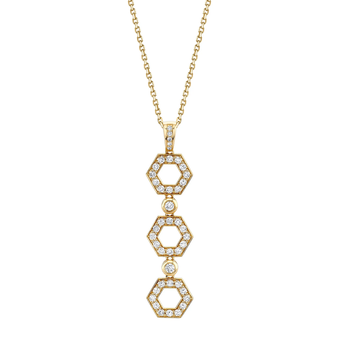 A front view of a yellow gold diamond pendant necklace against a white background. The ring features a drop design with shaped hexagons connected by round bezel-set diamonds.