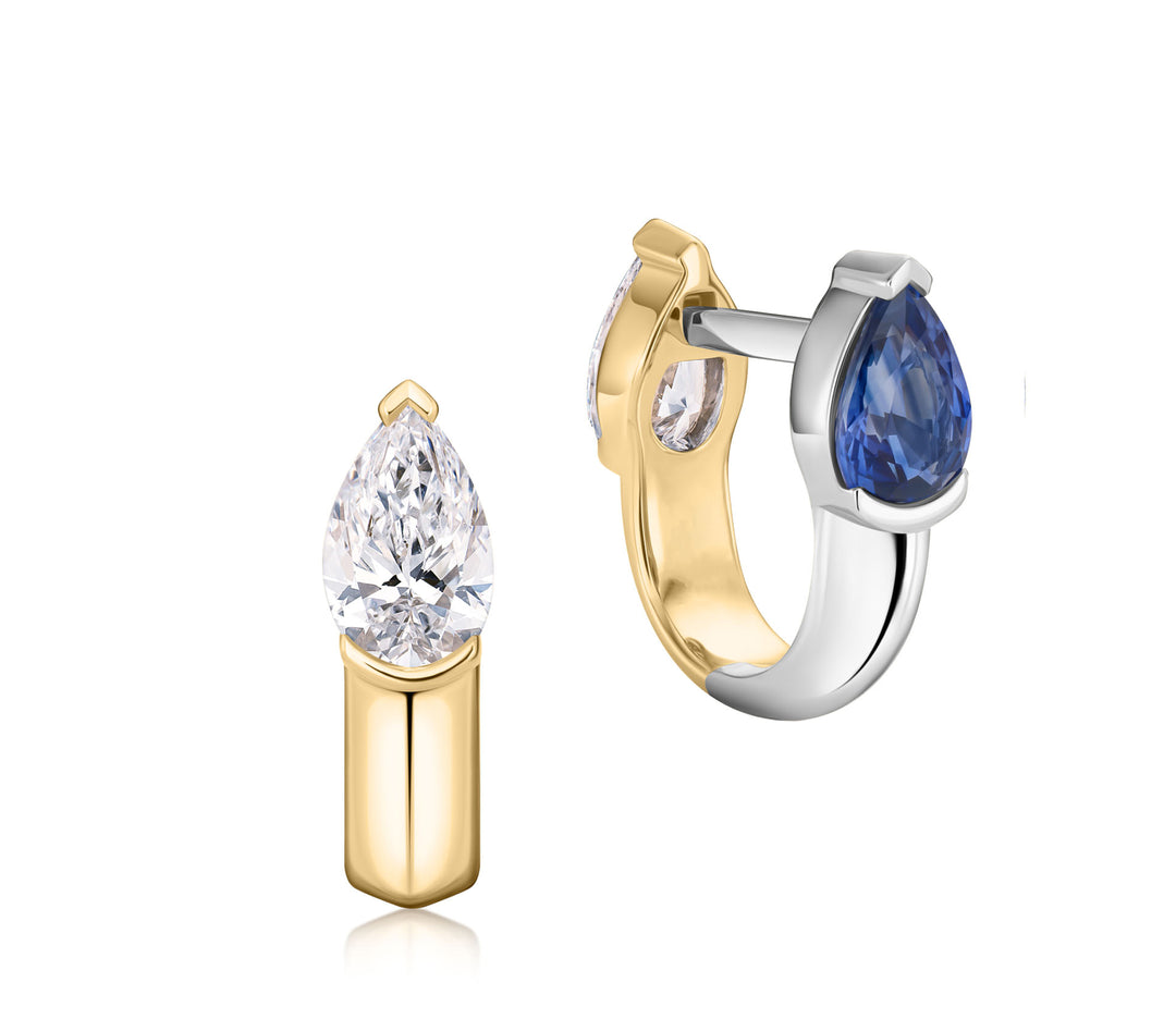 Reversible Mood Huggies in yellow gold and platinum, showing pear-shaped diamond and blue sapphire sides.