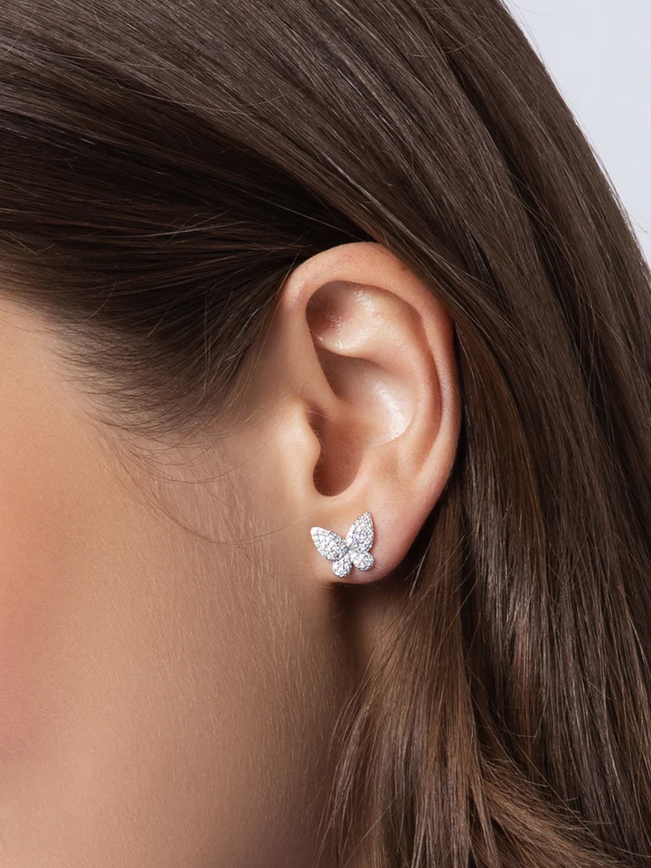 Model wearing a Phillips House petite diamond butterfly stud earring, showing its size and placement on the earlobe.