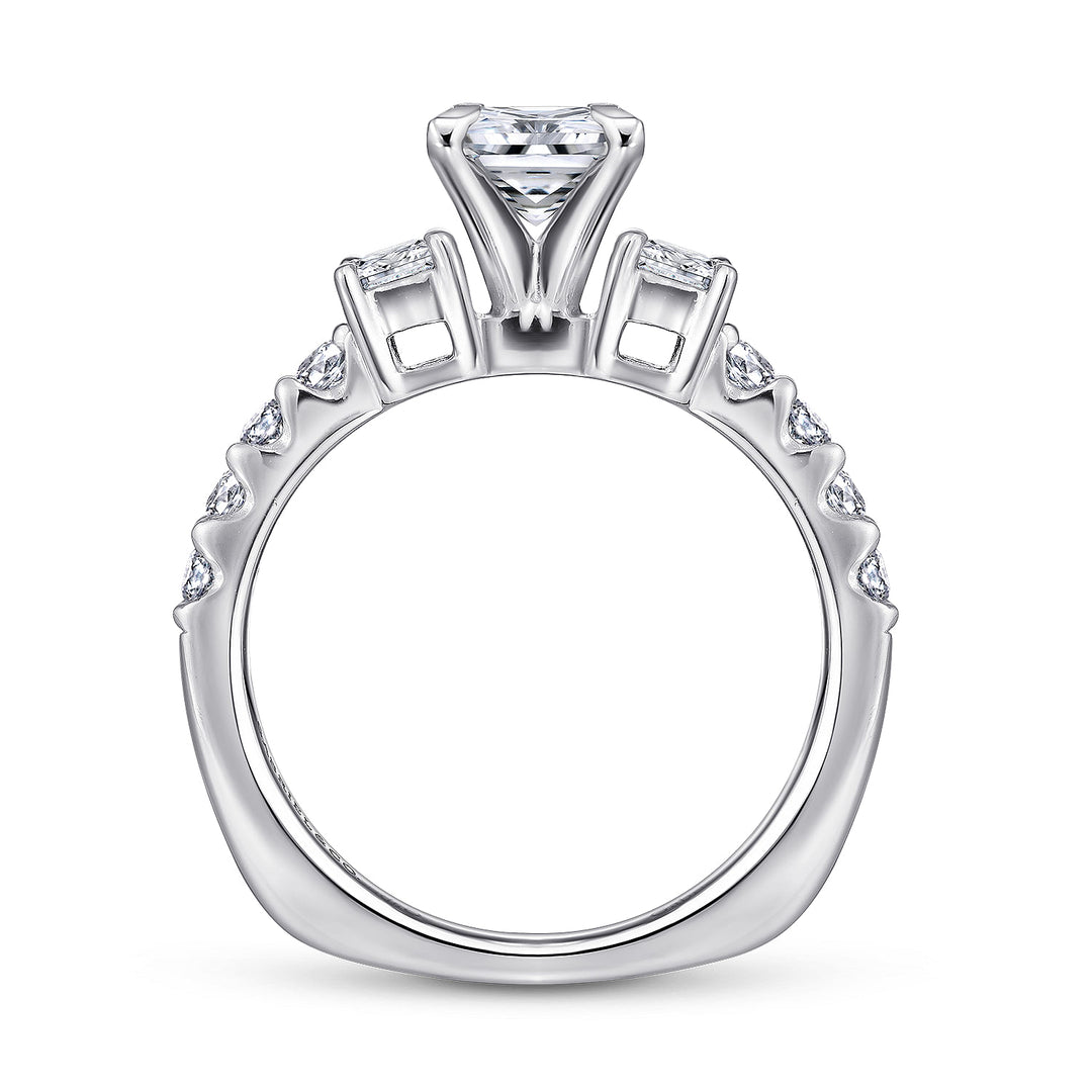 Profile view of a princess cut three stone engagement ring showing the elevated center setting, open side galleries and diamond-set band.
