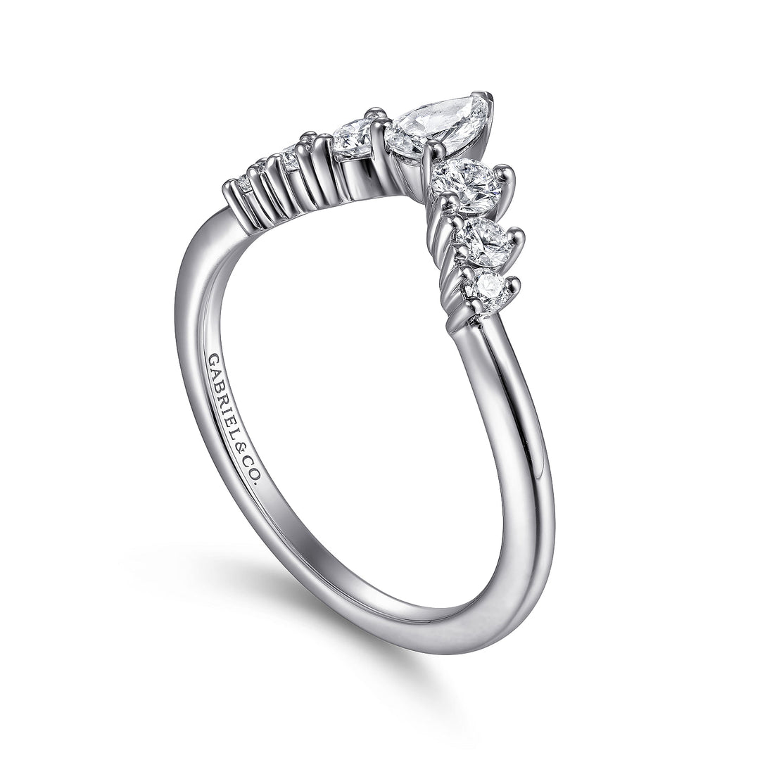 An angled view of a white gold wedding band against a white background. The ring features a princess-cut style with a pear-shaped center stone and six round-shaped side diamonds.