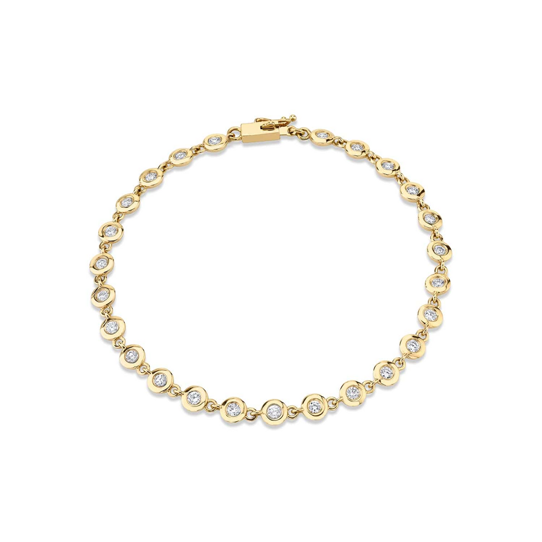 A front view of a yellow gold diamond tennis bracelet against a white background. The diamond bracelet features round bezels with diamonds.