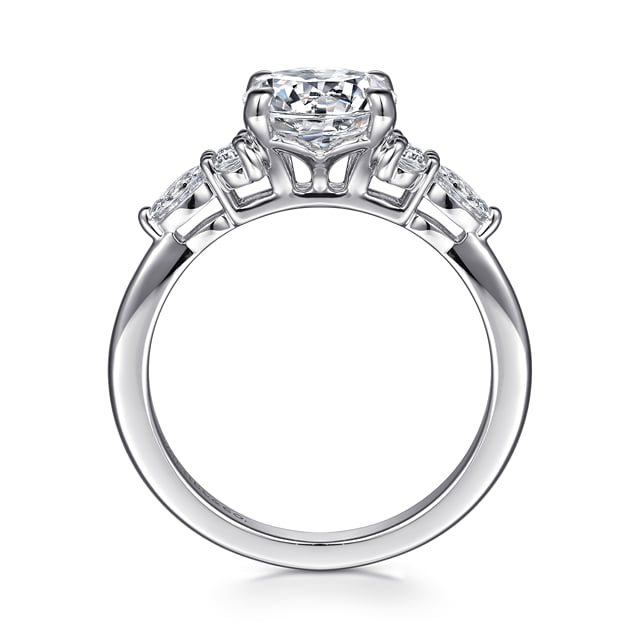 Profile view of a 14K white gold engagement ring showing the open gallery beneath the round center diamond and clustered side settings.