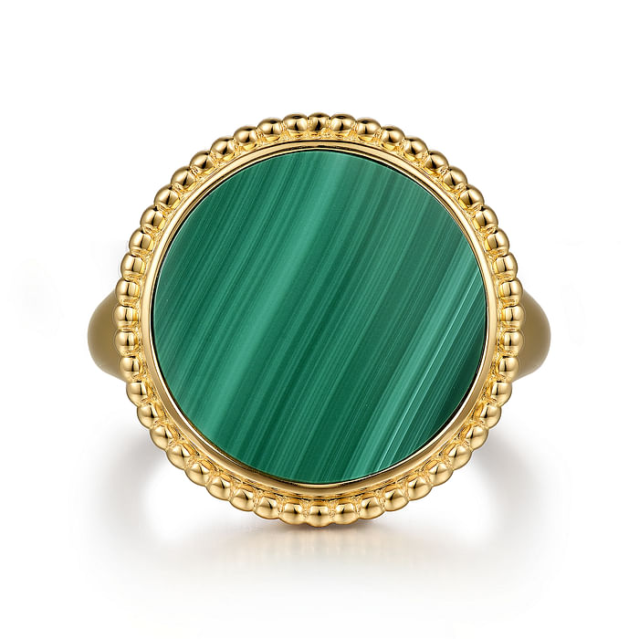 A front view of a yellow gold ring against a white background. The ring features an inlay of vibrant green malachite gemstone and yellow gold Bujukan beading.