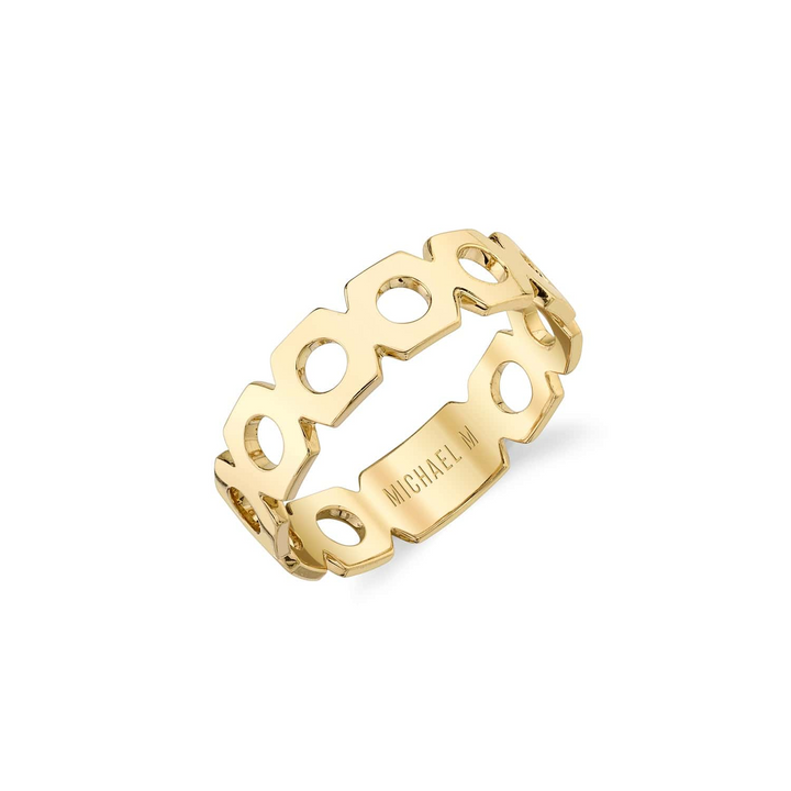 An angled view of a yellow gold wedding band against a white background. The ring features an eternity-style design with a continuous loop of hexagonal shapes and a blank round space at its center.
