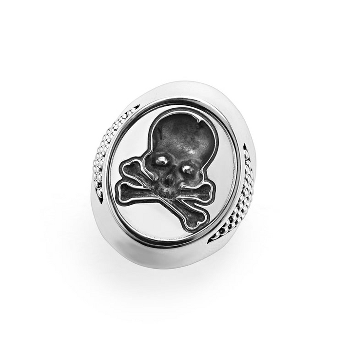 An angled view of a signet ring against a white background. The ring features a skull motif that forms this Sterling silver signet ring.