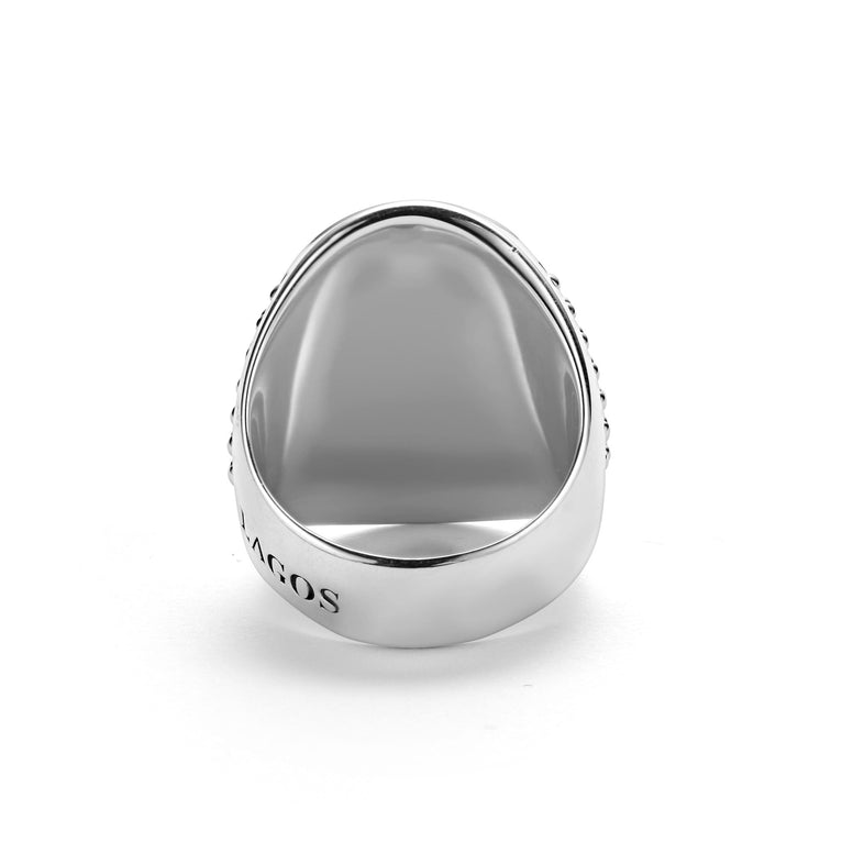 A front view of a signet ring against a white background. The ring features a skull motif that forms this Sterling silver signet ring.