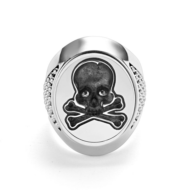 A front view of a signet ring against a white background. The ring features a skull motif that forms this Sterling silver signet ring.
