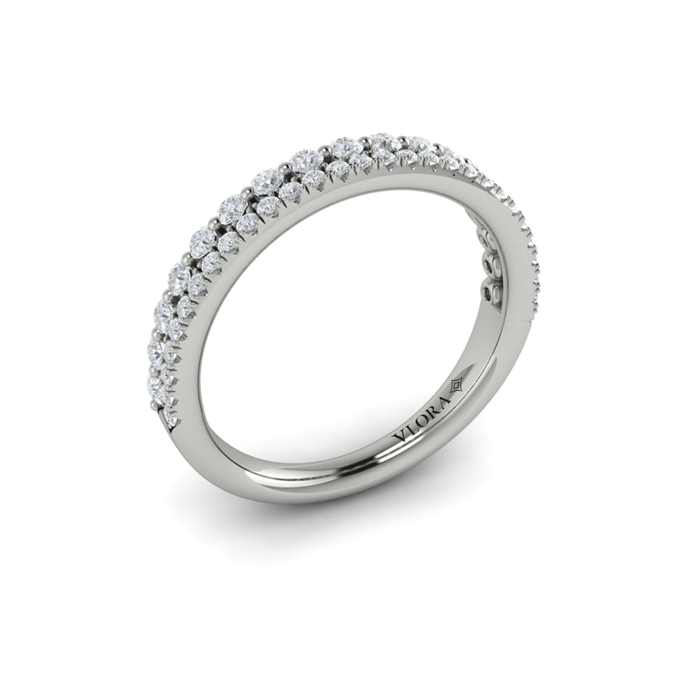 An angled view of a white gold bridal band is set against a white background. The bridal band features two rows of diamond-set accent diamonds; the top row has larger, round-shaped diamonds.