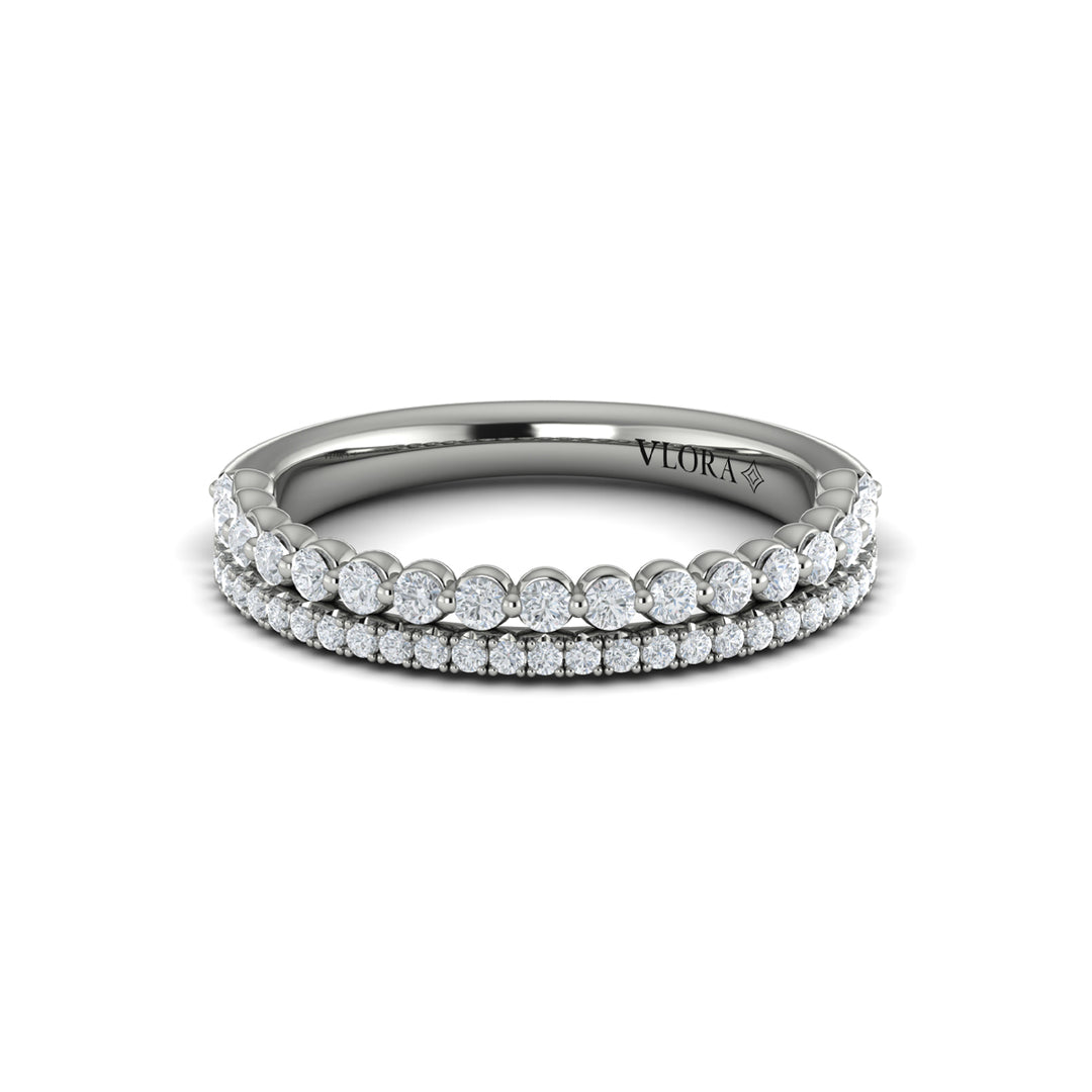 A front view of a white gold bridal band is set against a white background. The bridal band features two rows of diamond-set accent diamonds; the top row has larger, round-shaped diamonds.