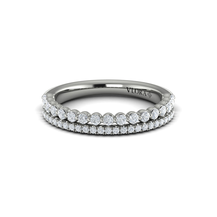 A front view of a white gold bridal band is set against a white background. The bridal band features two rows of diamond-set accent diamonds; the top row has larger, round-shaped diamonds.