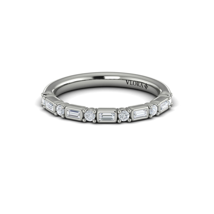 A front view of a white gold band set against a white background. The ring features a half-eternity east-west emerald and round diamonds alternating design.