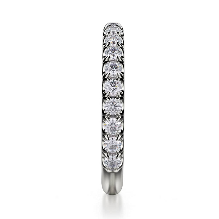 A side view of a prong-set diamond-set ring with round-shaped diamonds on a white gold band.