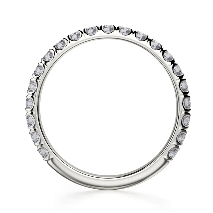 A top view of a white gold wedding band against a white background. The ring features a 3/4 eternity style with brilliant round-shaped prong-set diamonds.