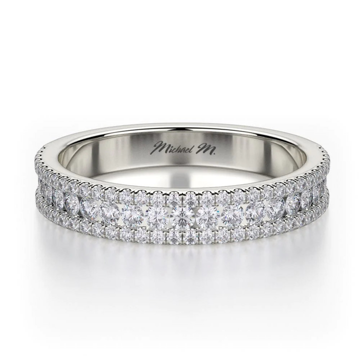 A front view of a platinum wedding band against a white background. The ring features a half-eternity style with three rows of brilliant, round-shaped, prong-set diamonds.