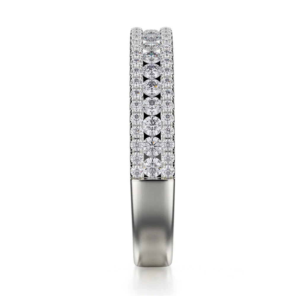 A side profile view of a platinum wedding band against a white background. The ring features a half-eternity style with three rows of brilliant, round-shaped, prong-set diamonds.