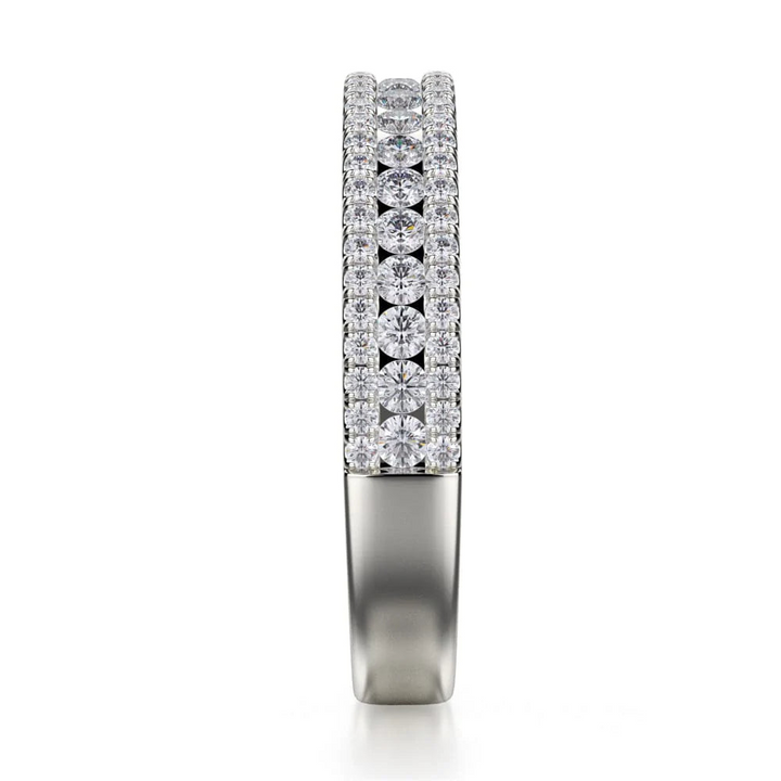 A side profile view of a platinum wedding band against a white background. The ring features a half-eternity style with three rows of brilliant, round-shaped, prong-set diamonds.