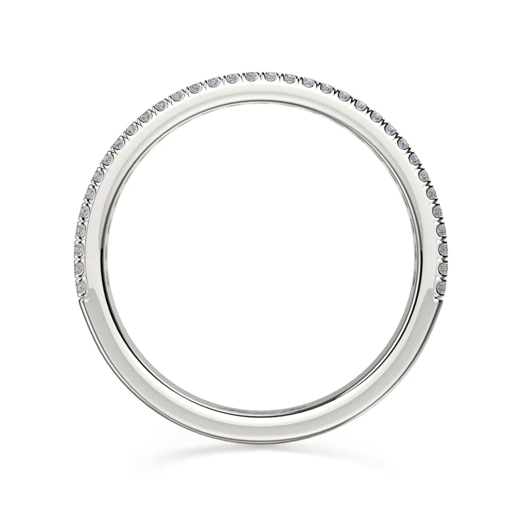 A top view of a platinum wedding band against a white background. The ring features a half-eternity style with three rows of brilliant, round-shaped, prong-set diamonds.