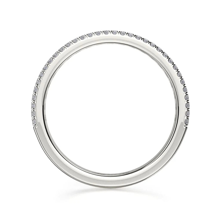 A top view of a platinum wedding band against a white background. The ring features a half-eternity style with three rows of brilliant, round-shaped, prong-set diamonds.