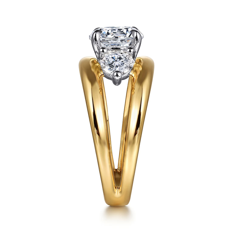 End view of a two-tone three stone engagement ring showing a round side diamond between the open yellow gold split shank shoulders.