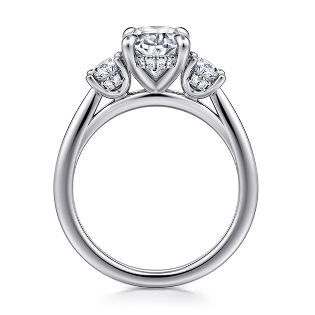 Profile view of a 14K white gold three-stone engagement ring showing the elevated settings, hidden diamond halo and open gallery.