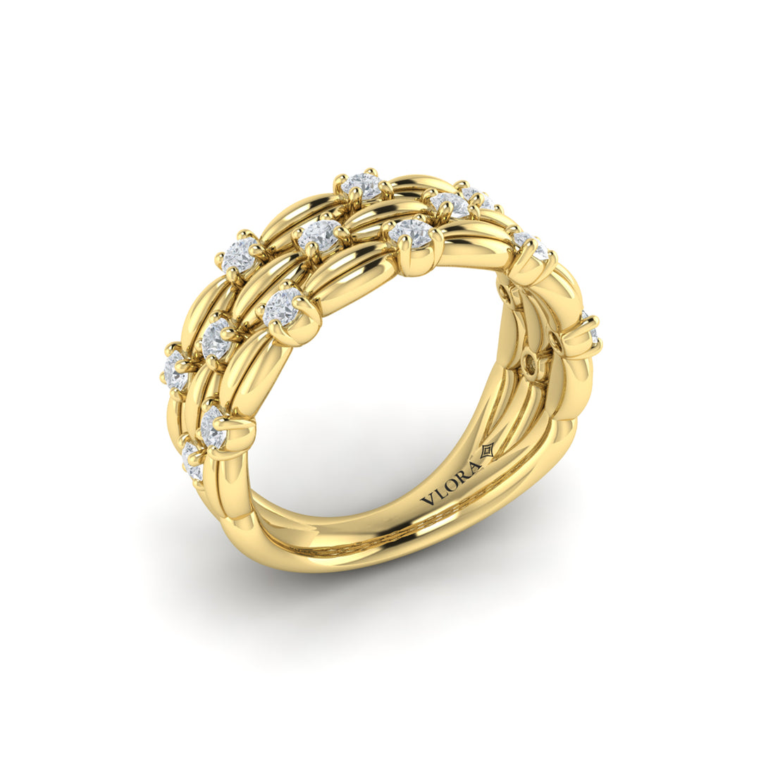 An angled view of a yellow gold ring is set against a white background. The ring features round-shaped diamonds adorning an elegant, scalloped silhouette, three rows, and a polished finish.