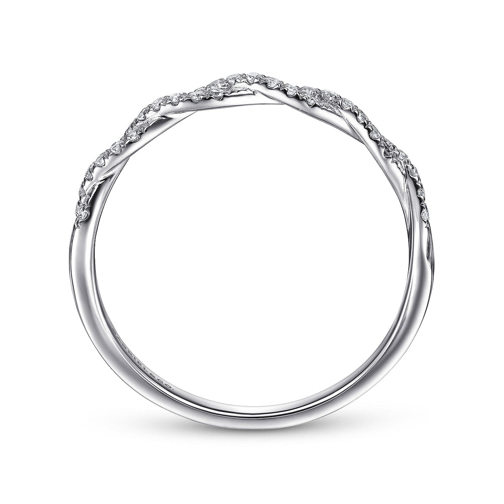 A side view of a white gold ring in the middle of a white background. The ring features a half-eternity design with a diamond-set weave design at the top.
