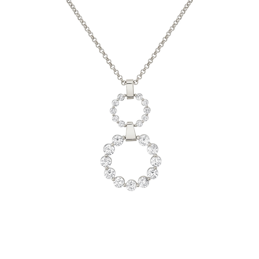 A white gold drop necklace is set against a white background. The necklace features two sleek silver bars and two circle motifs; the smaller circle has 10 round-shaped diamonds, and the larger circle on the bottom has 11 round-shaped diamonds.