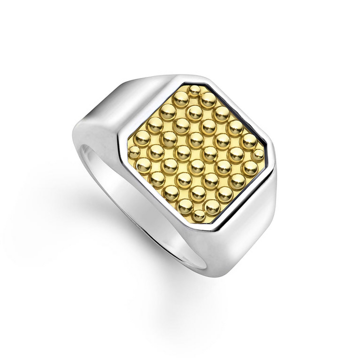 A yellow gold ring angled to the right against a white background. The ring features a square gold bead motif in the middle and a thick silver band.