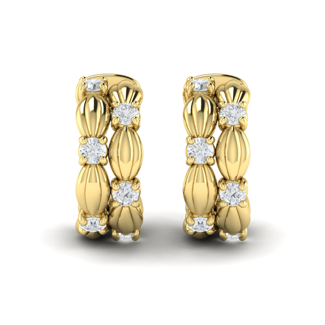 Vlora Madeleine yellow gold hoop earrings featuring sculpted scallop-shell details bordered by two rows of diamonds.