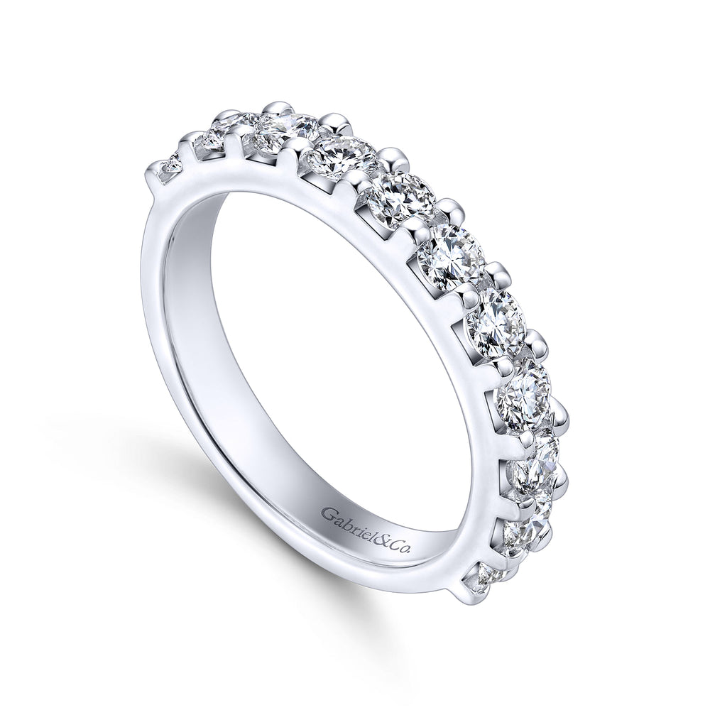 An angled view of a white gold wedding band against a white background. The ring features a half-eternity style with a row of brilliant diamonds set in white gold.