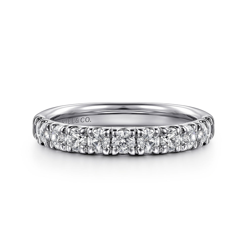 A front view of a white gold wedding band against a white background. The ring features a half-eternity style with a row of brilliant diamonds set in white gold.