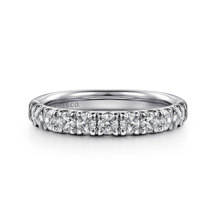 A front view of a white gold wedding band against a white background. The ring features a half-eternity style with a row of brilliant diamonds set in white gold.