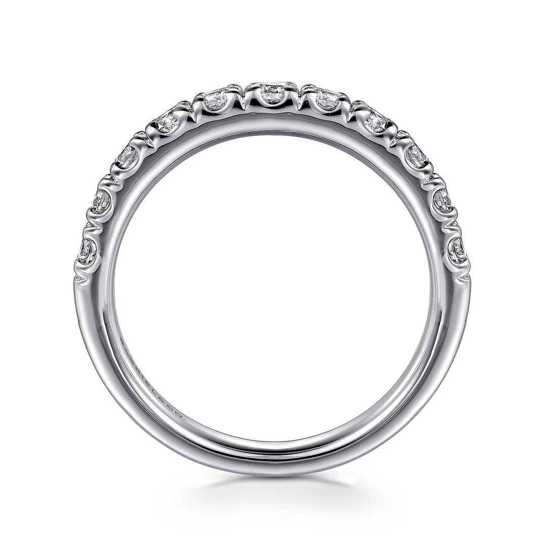 A side profile view of a white gold wedding band against a white background. The ring features a half-eternity style with a row of brilliant diamonds set in white gold.